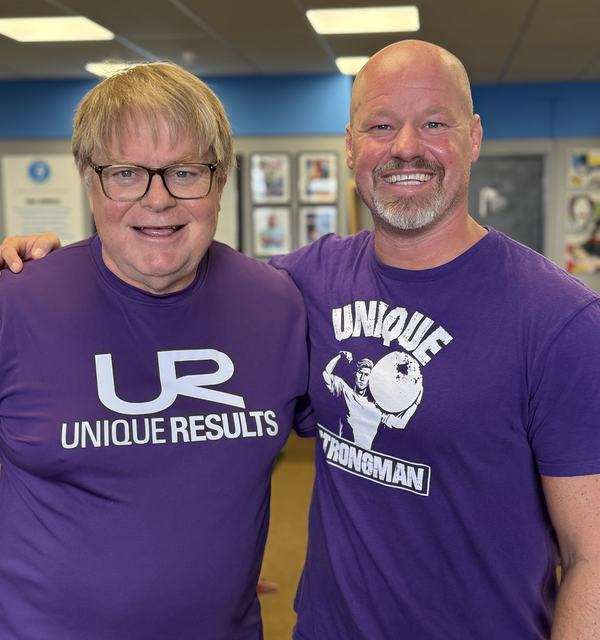 A smiling Unique Results member with his coach in the Chelmsford studio