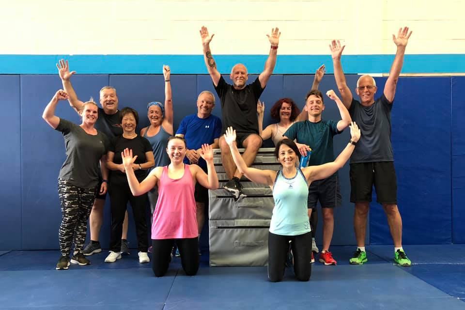 A group of Unique Results members celebrating together in the studio